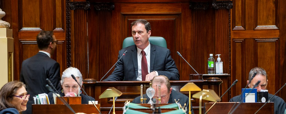 The Speaker looks over the table in the Legislative Assembly, with the mace in the foreground.