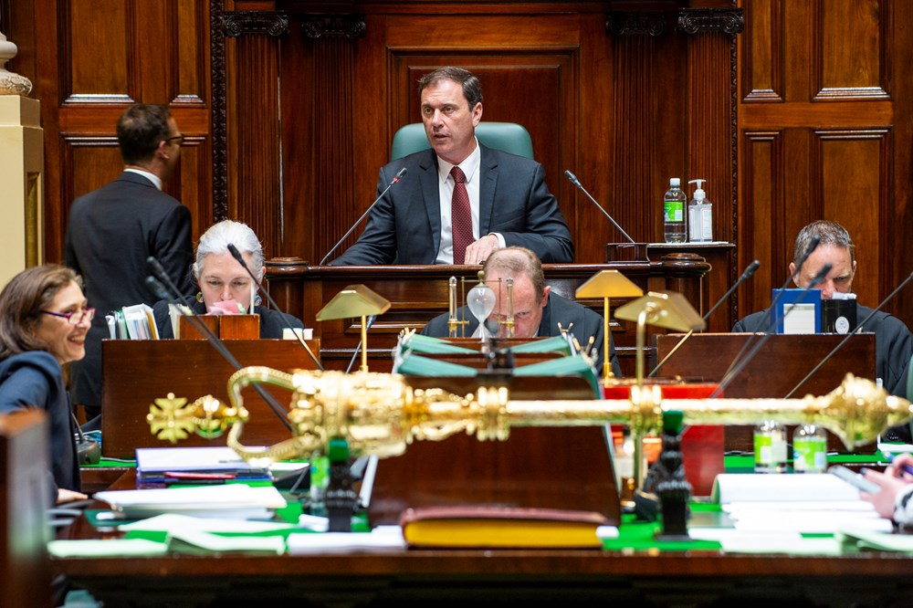 The Speaker looks over the table in the Legislative Assembly, with the mace in the foreground.