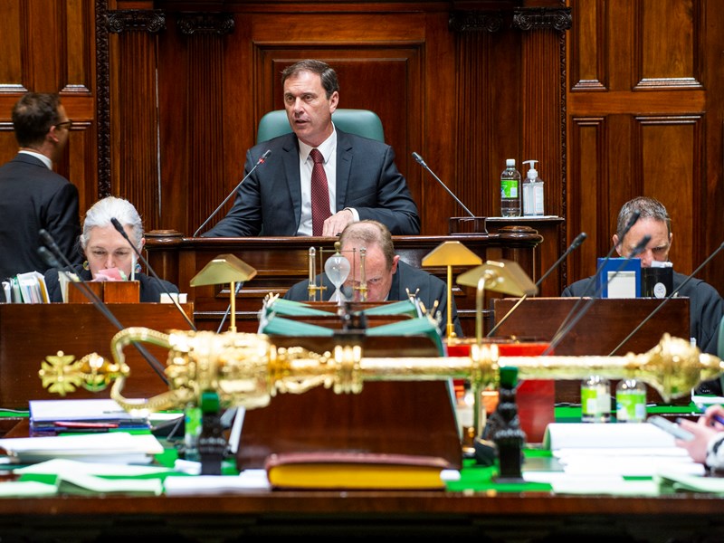 The Speaker looks over the table in the Legislative Assembly, with the mace in the foreground.
