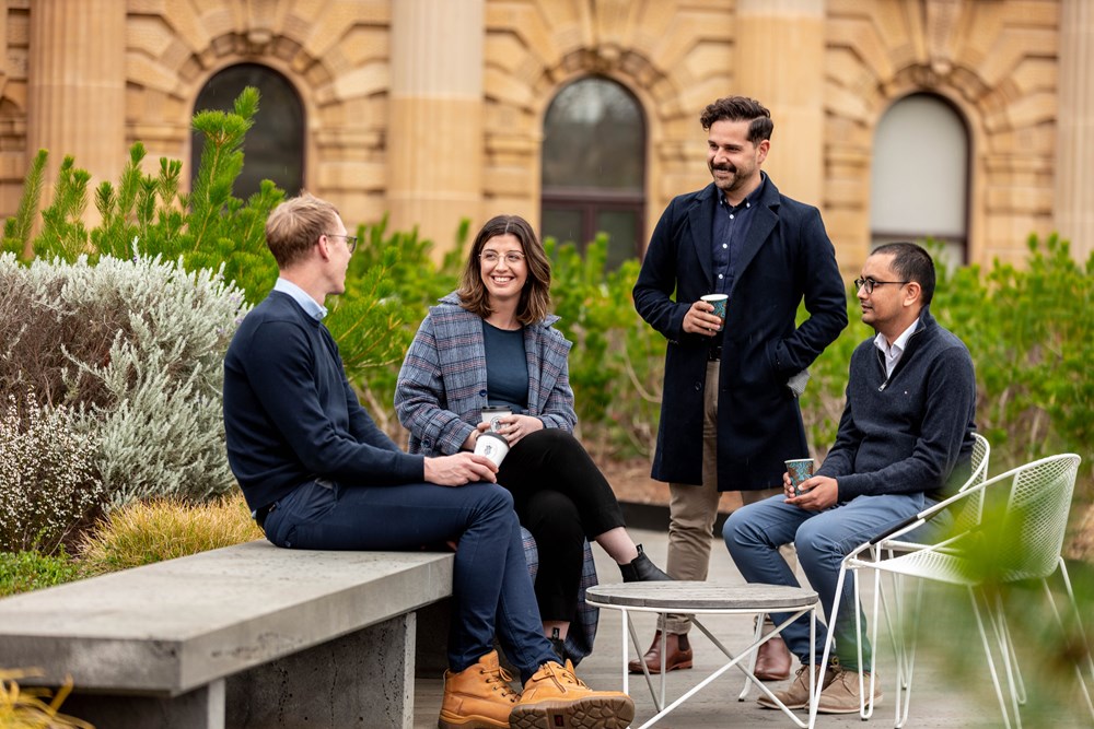 Four Parliament employees enjoy a break in the gardens