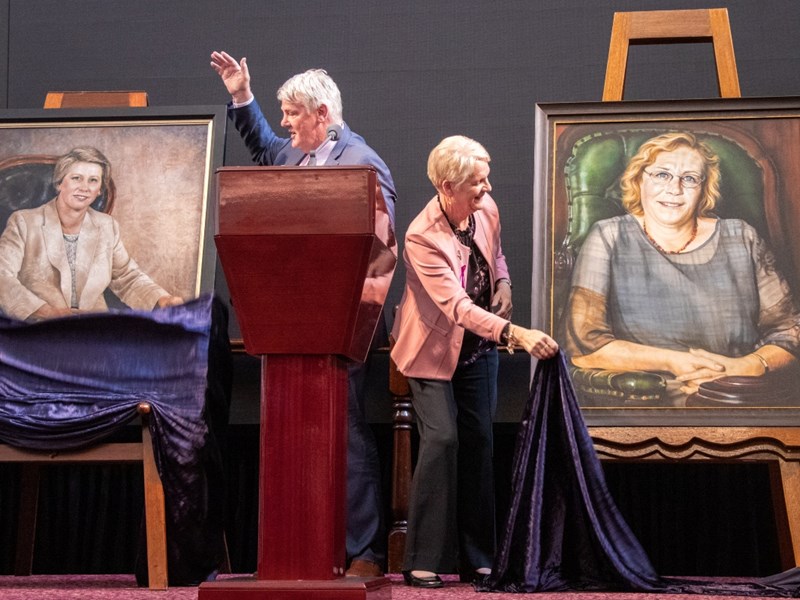 Presiding Officers Shaun Leane and Maree Edwards unveiling portraits of Monica Gould and Judy Maddigan.
