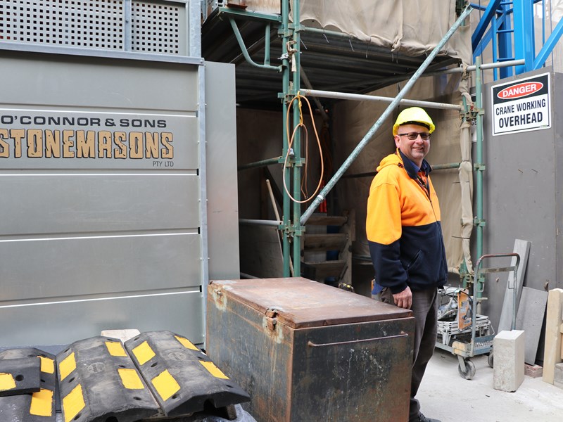 Tim O'Connor, stonemason, stands at the worksite.