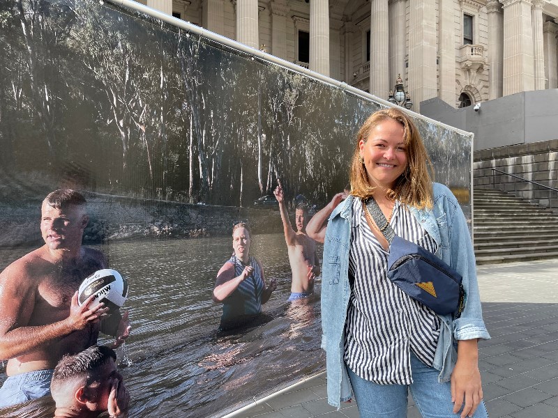 Photographer Alana Holmberg  at Parliament Steps with the large-scale installation that features her photographs from regional Victoria.