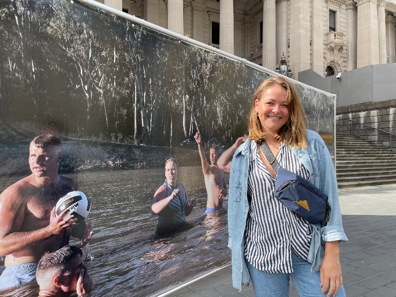 Photographer Alana Holmberg at Parliament Steps with the large-scale installation that features her photographs from regional Victoria.