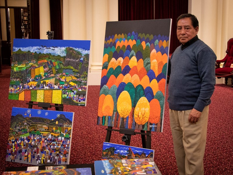 Luis Millingalli displaying his art from Ecuador in Queen's Hall.