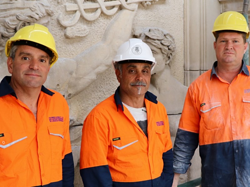 HIGH ACHIEVERS: Stonemasons Joe and Tom Michienzi with Glenn Torbet working on the facade of Parliament House.