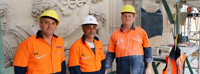 HIGH ACHIEVERS: Stonemasons Joe and Tom Michienzi with Glenn Torbet working on the facade of Parliament House.