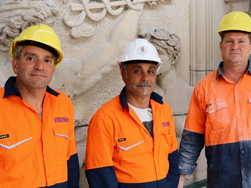 HIGH ACHIEVERS: Stonemasons Joe and Tom Michienzi with Glenn Torbet working on the facade of Parliament House.