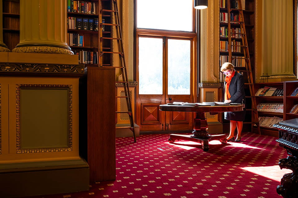 Member Suzanna Sheed browses newspapers in the parliamentary library.